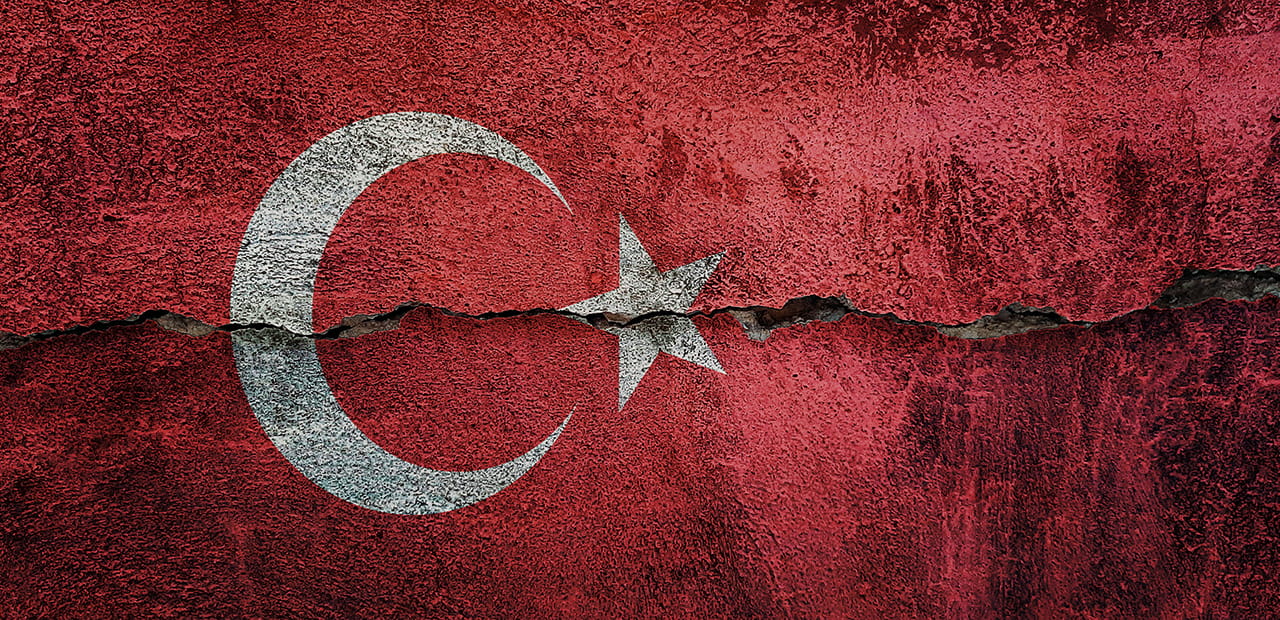 Turkey flag on a cracked wall.