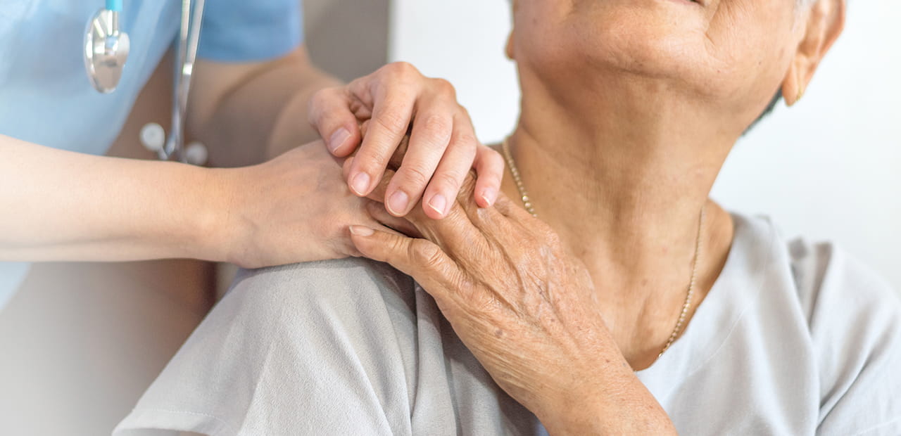 Doctor physician hand on happy elderly senior patient