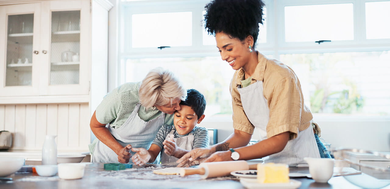 Grandmother, mother, and child in the kitchen baking cookies