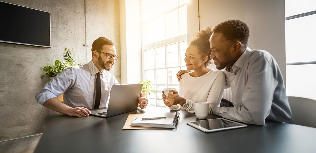 A couple having a meeting with an advisor.
