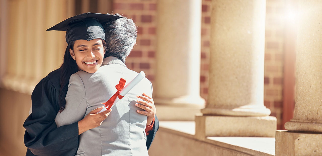 A woman hugging at her graduation.