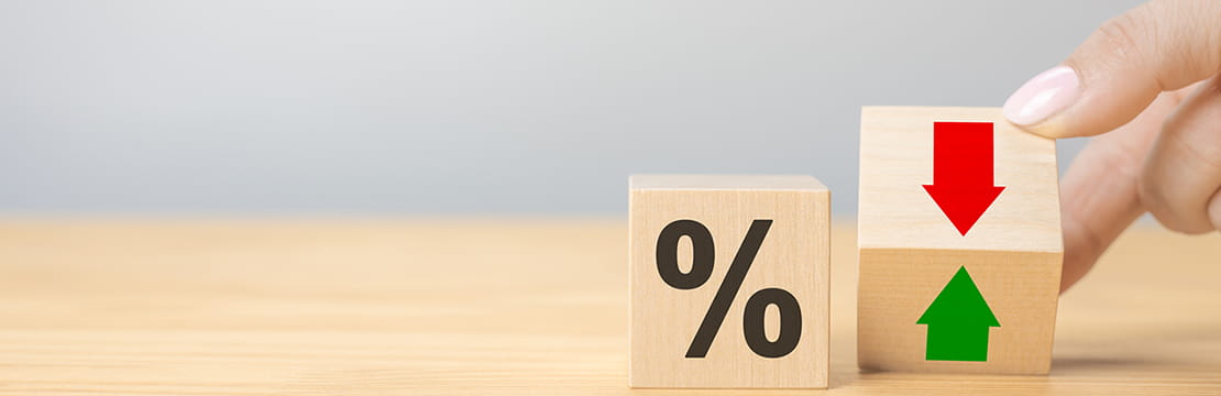 Interest rate financial and mortgage rates concept. Hand flip wood cube change arrow down to up.