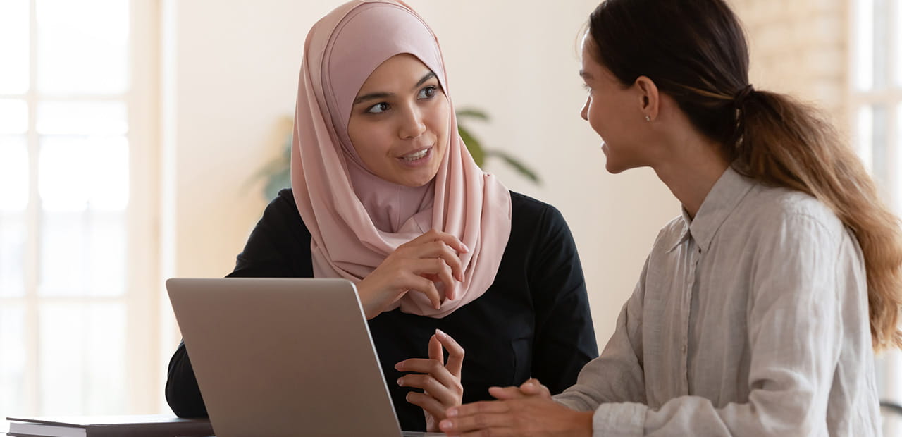 Multiracial young female employees in a meeting.