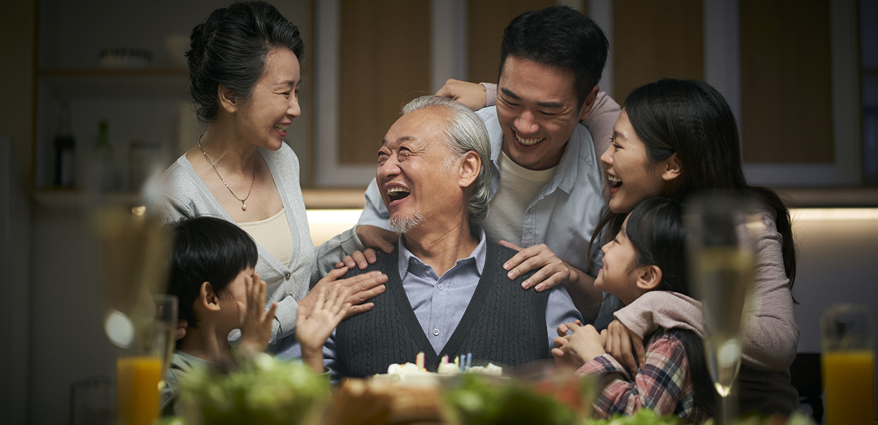happy three generation asian family celebrating grandpa's birthday at home