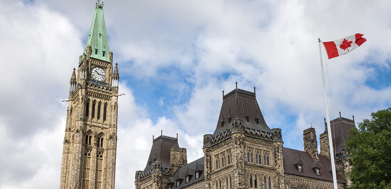 Parliament Hill Clock Tower And Flag Blowing