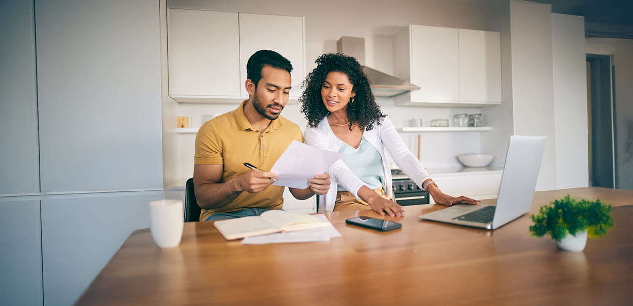 A couple looking at documents in the kitchen