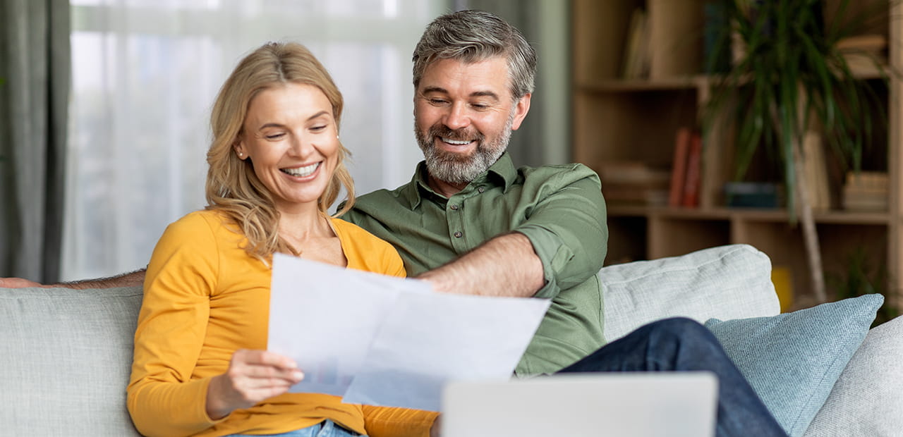 Caucasian couple reading documents.