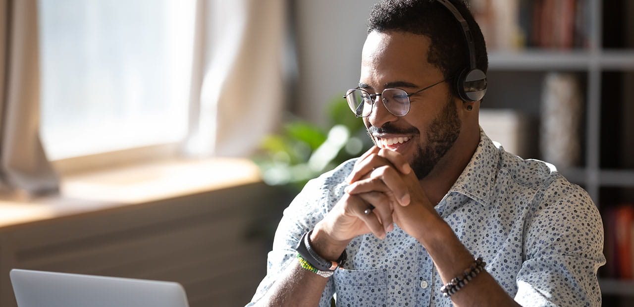 A man grinning with his headset on