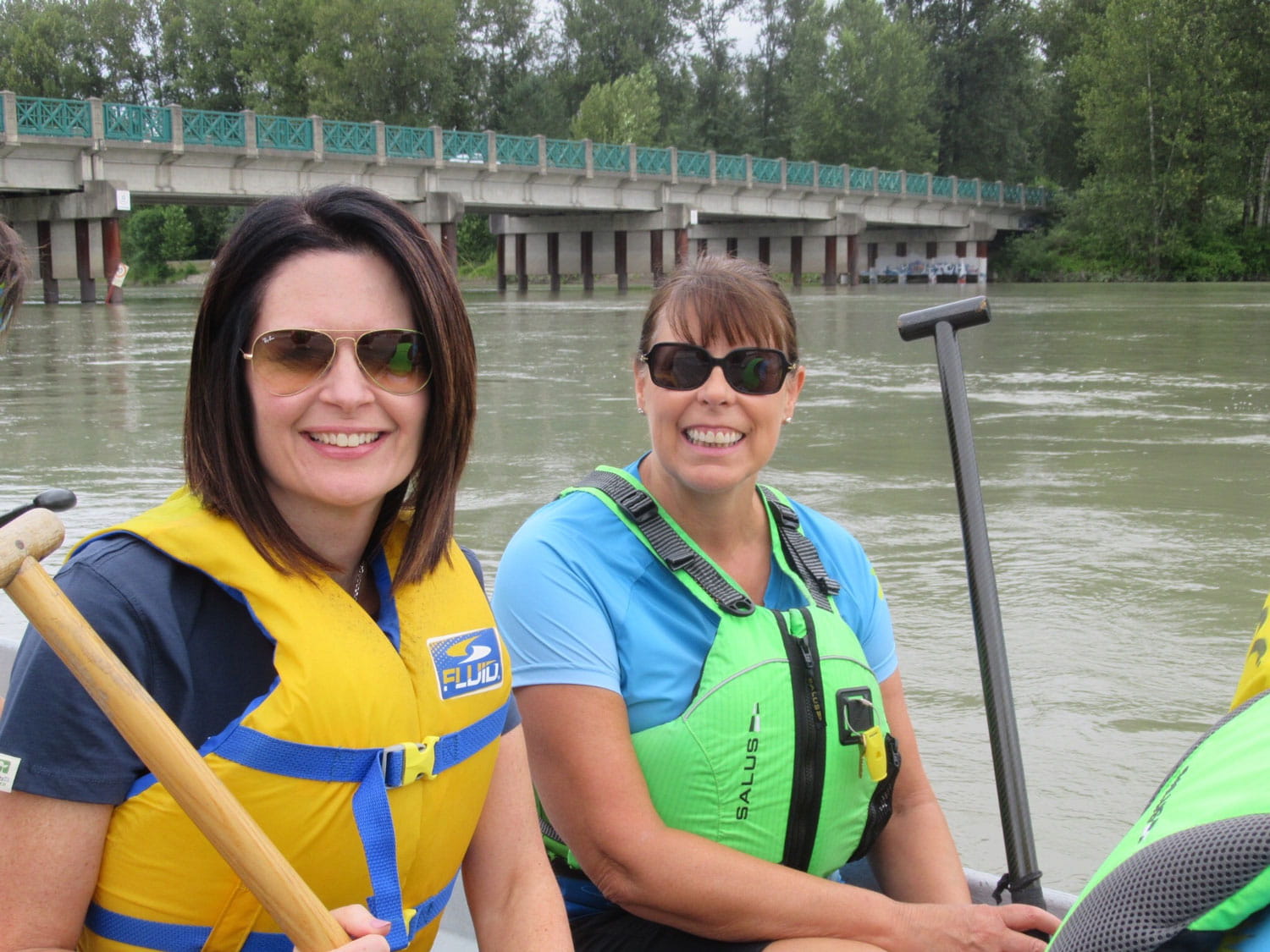 Two women holding oars