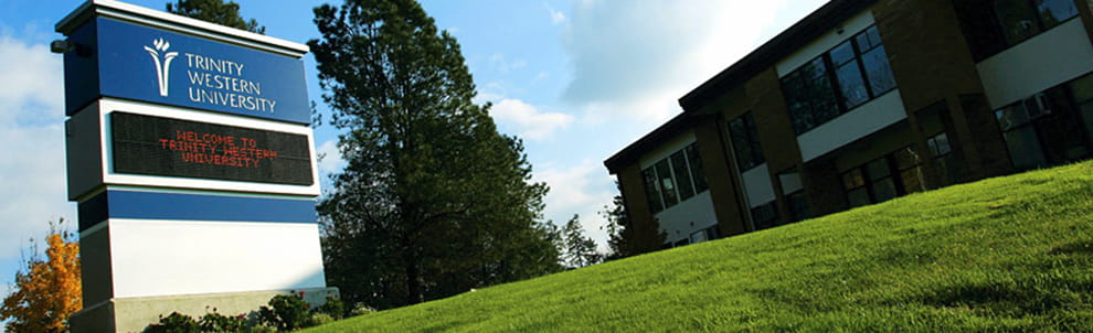 Trinity Western University sign on a lawn.