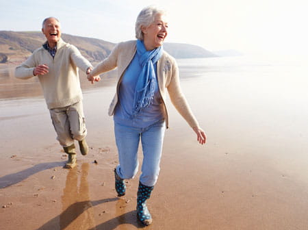 bill and marge walking on the beach laughing