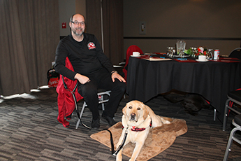 Man(Stephen) in a wheelchair with dog(Sarge)